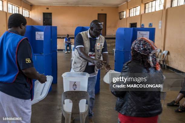 Polling station officials prepare to seal the ballot boxes at the voting station during Eswatini's parliamentary elections at the Msunduza Hall in...