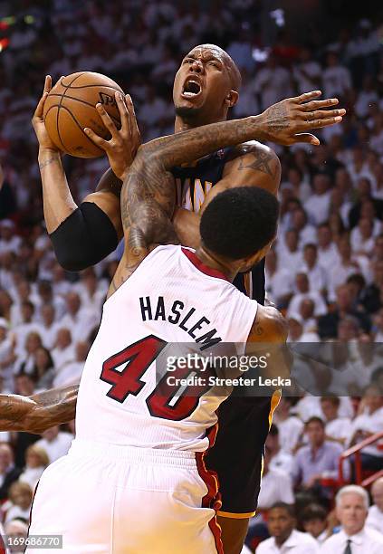 David West of the Indiana Pacers drives to the basket against Udonis Haslem of the Miami Heat during Game Five of the Eastern Conference Finals at...