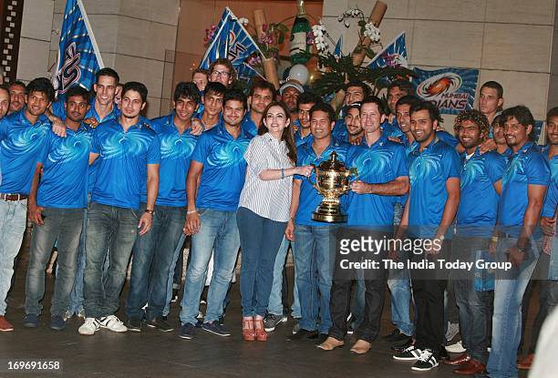 Nita Ambani poses with the Mumbai Indians team at the party hosted by her to celebrate her team’s victory in IPL finals.
