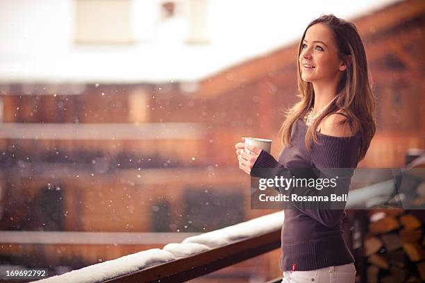 portrait of girl smiling in the snow on balcony - verbier ストックフォトと画像