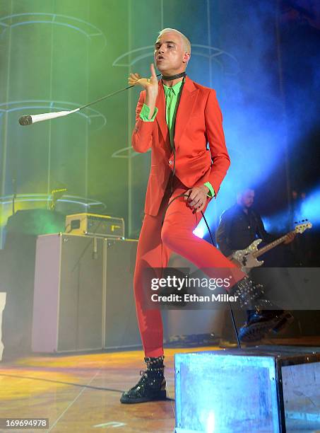 Neon Trees frontman Tyler Glenn swings a microphone around his neck as he and bassist Branden Campbell perform at the Couture Las Vegas jewelry show...