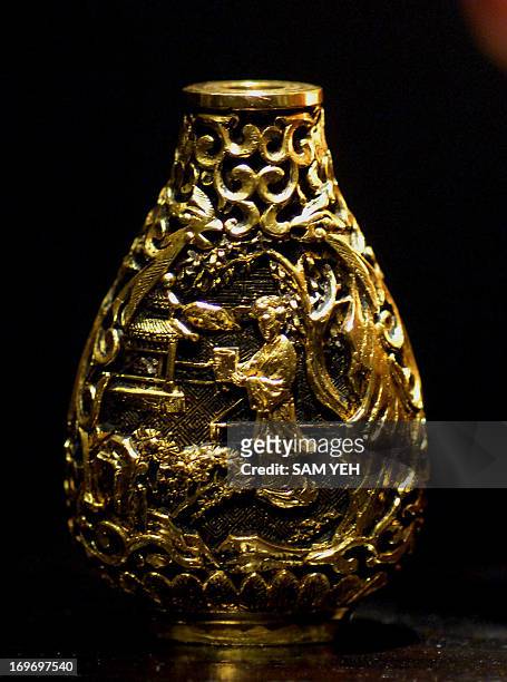 Gold Ching Dynasty snuff bottle is on display during an exhibition in Taipei on August 28, 2008. The snuff bottle was used to contain powdered...