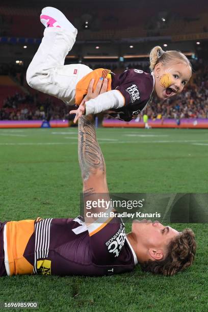 Reece Walsh of the Broncos celebrates with his daughter Leila after winning the NRL Preliminary Final match between Brisbane Broncos and New Zealand...