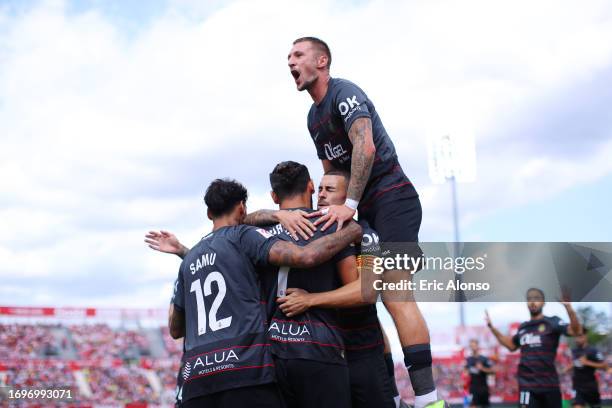 Vedat Muriqi of RCD Mallorca celebrates with teammates after scoring the team's first goal during the LaLiga EA Sports match between Girona FC and...