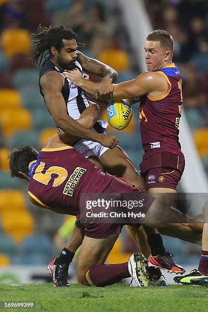 Hertier O'Brien of the Magpies is tackled during the round ten AFL match between the Brisbane Lions and the Collingwood Magpies at The Gabba on May...
