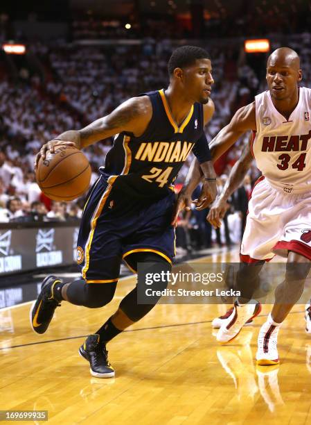 Paul George of the Indiana Pacers handles the ball against Ray Allen of the Miami Heat during Game Five of the Eastern Conference Finals at...