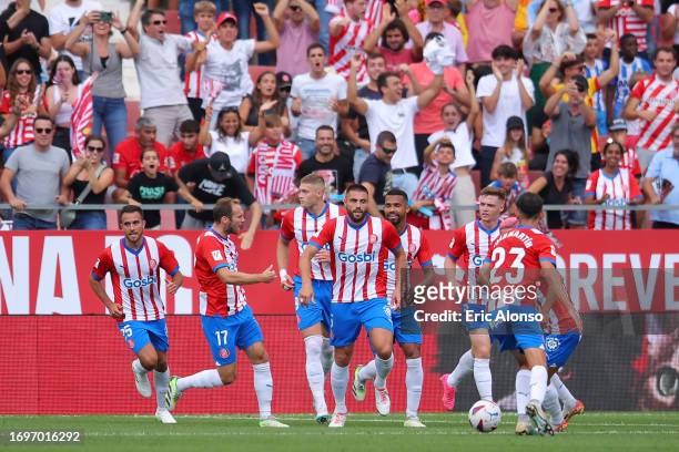 David Lopez of Girona celebrates with teammates after scoring the team's first goal during the LaLiga EA Sports match between Girona FC and RCD...