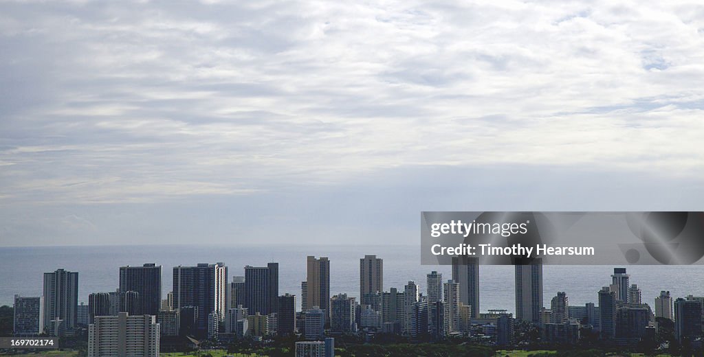 City skyline with ocean and clouds beyond