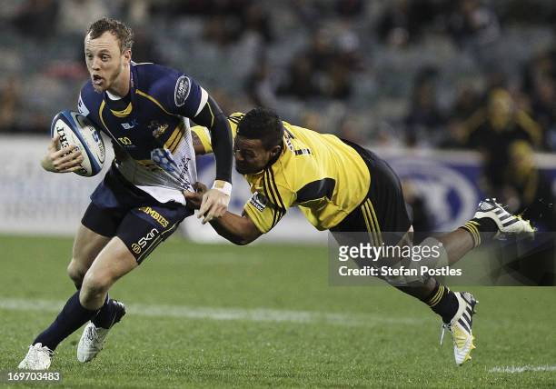 Jesse Mogg of the Brumbies is tackled during the round 16 Super Rugby match between the Brumbies and the Hurricanes at Canberra Stadium on May 31,...