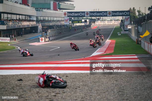 MotoGP riders after lap one at turn one - marshals still cleaning turn one after a big crash at the start during the Sprint of the MotoGP IndianOil...