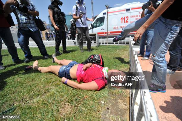 Wounded woman lays on Taksim Square after clashes with riot police on May 31, 2013 during a protest against the demolition of Taksim Gezi Park, in...