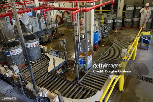May 30: A worker loads containers of nitrocellulose, also known cellulose nitrate, flash paper, flash cotton, guncotton, flash string as he readies...