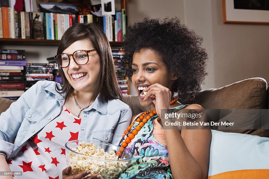 Women watching television in livingroom.