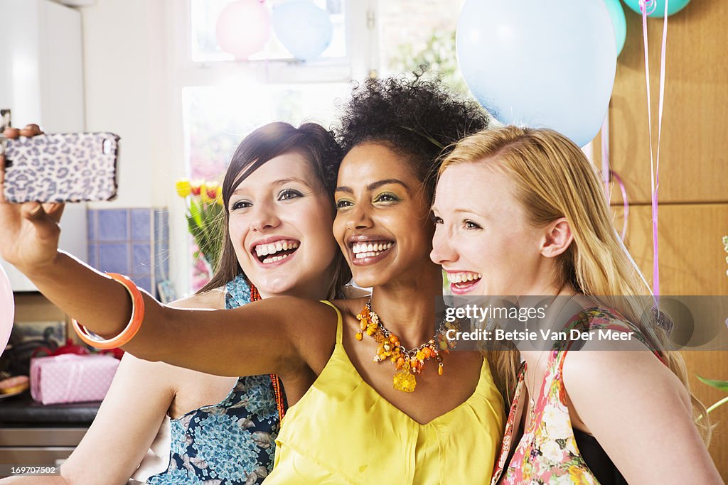 Women taking phones of themselves on phone.