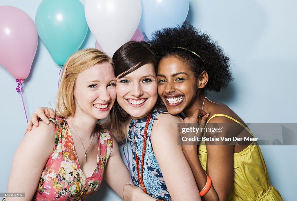 Portrait of women together holding balloons