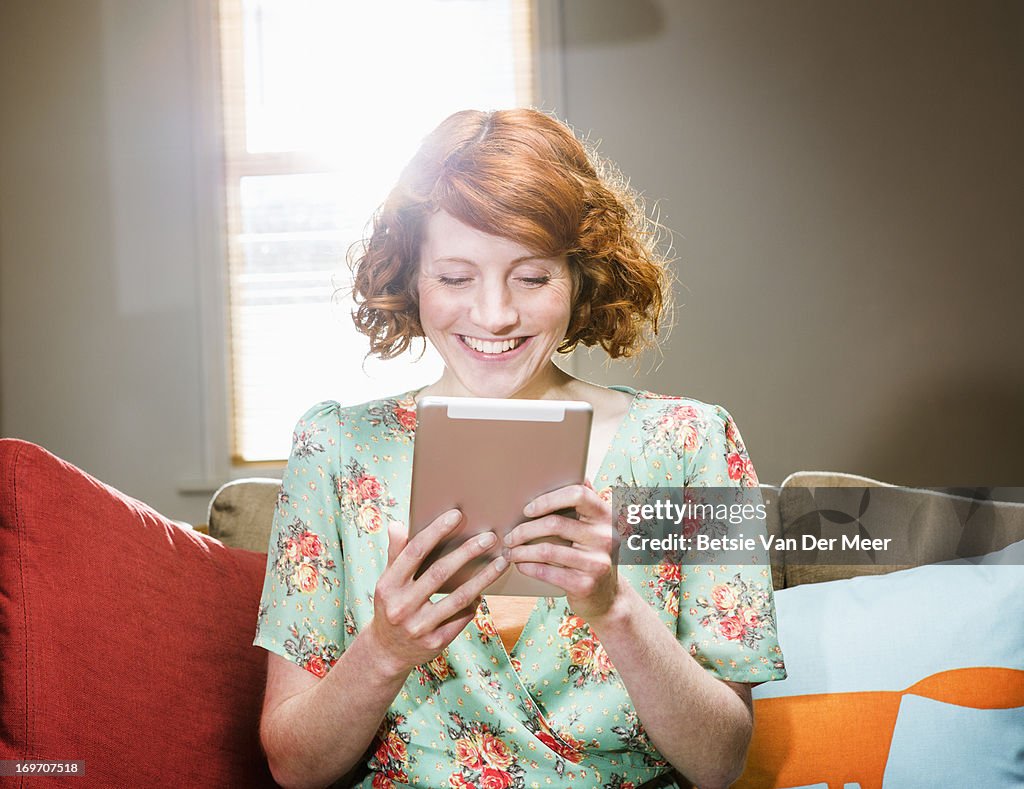 Woman communicating through digital tablet
