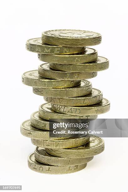 one pound coins balanced in stack - one pound coin stock pictures, royalty-free photos & images