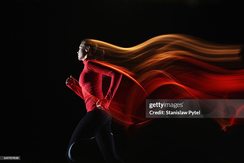 Girl running and leaving light streaks