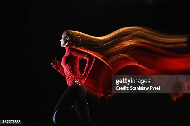 girl running and leaving light streaks - women on the move stock pictures, royalty-free photos & images