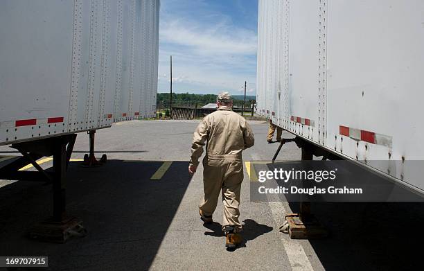 May 30: A worker walks past tractor trailers full of nitrocellulose, also known cellulose nitrate, flash paper, flash cotton, guncotton, flash string...