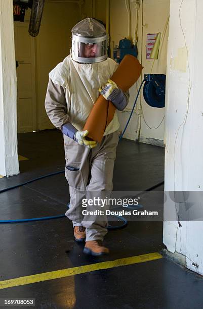 May 30: A worker preps solid rocket propellant at the Radford Army Ammunition Plant. The primary mission of the plant is to manufacture propellants...