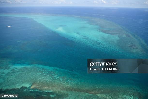 This photo taken on September 28, 2023 shows an aerial view of the mouth of the Chinese-controlled Scarborough Shoal, seen without any barriers...