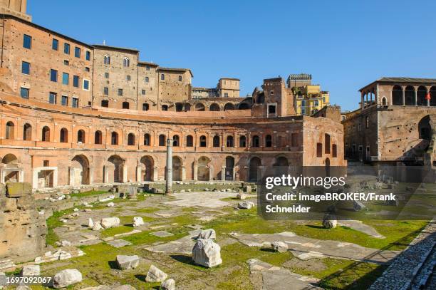 View of historic Forum of Traian Foro Traiano from antiquity with building in semicircle at rear with colonnade in foreground forecourt open space with column fragments remains of marble columns, Rome, Lazio, Italy