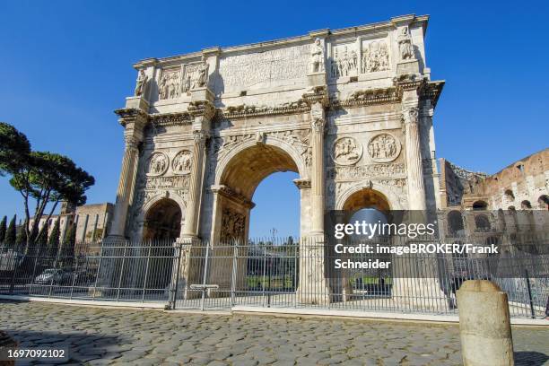 Perspective view from close up of Arch of Constantine Triumphal Arch of Emperor Constantine without tourists deserted in the background right Colosseum, Rome, Latium, Italy