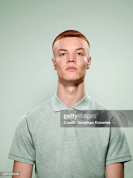 portrait of a red hair male in pastel colours - polohemd stock-fotos und bilder