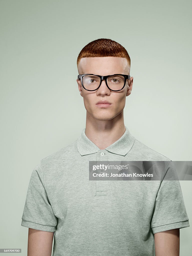 Portrait of a red hair male with glasses on