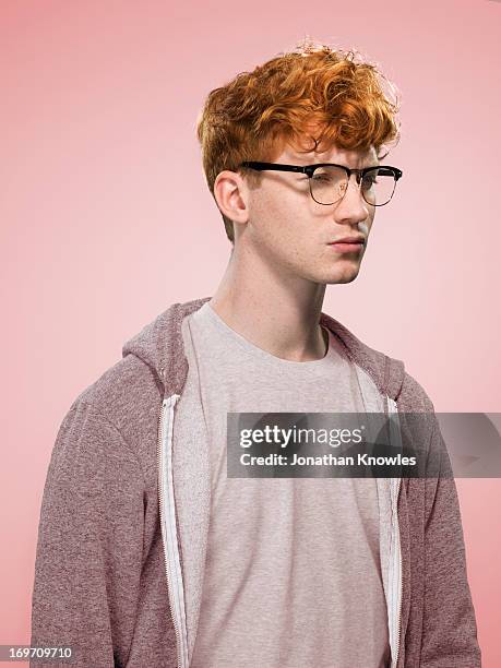 male with curly red hair and glasses looking away - man and his hoodie imagens e fotografias de stock