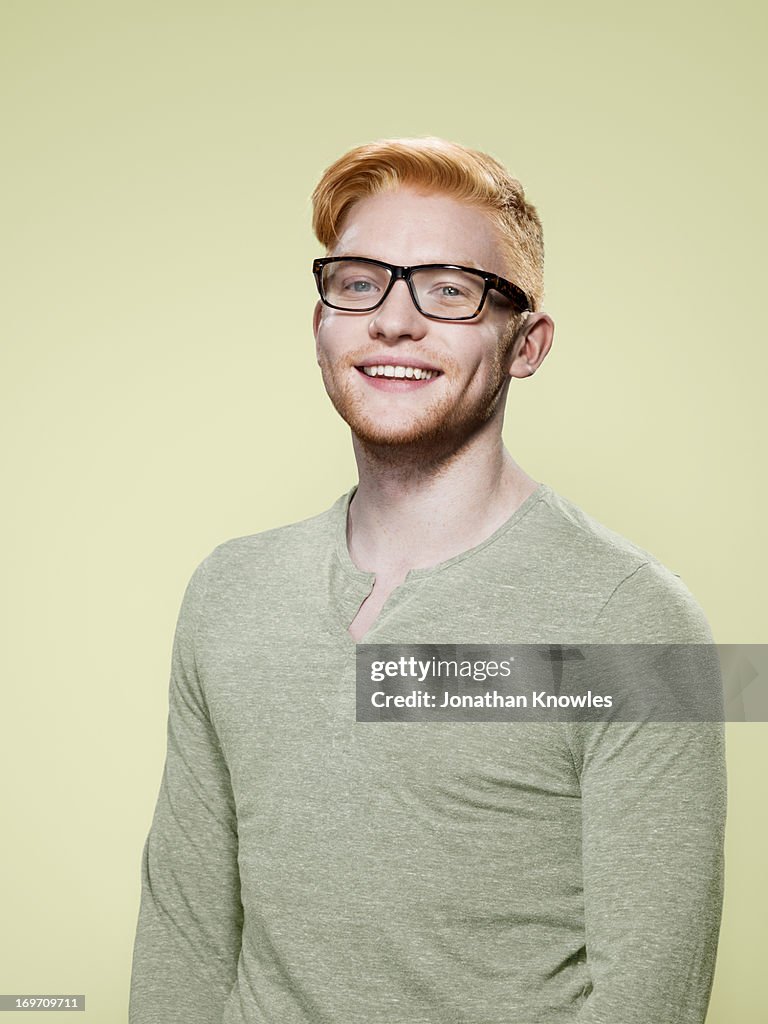 Portrait of a red hair male with glasses smiling