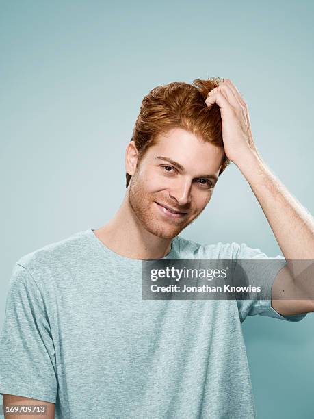red hair male smiling, hand running through hair - hand in den haaren stock-fotos und bilder