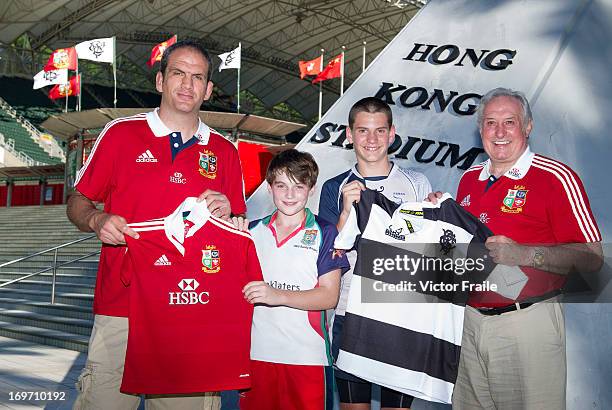 Former British & Irish Lions players Martin Johnson , who was captain, and Gareth Edwards present team jerseys to youngsters participating in a HSBC...