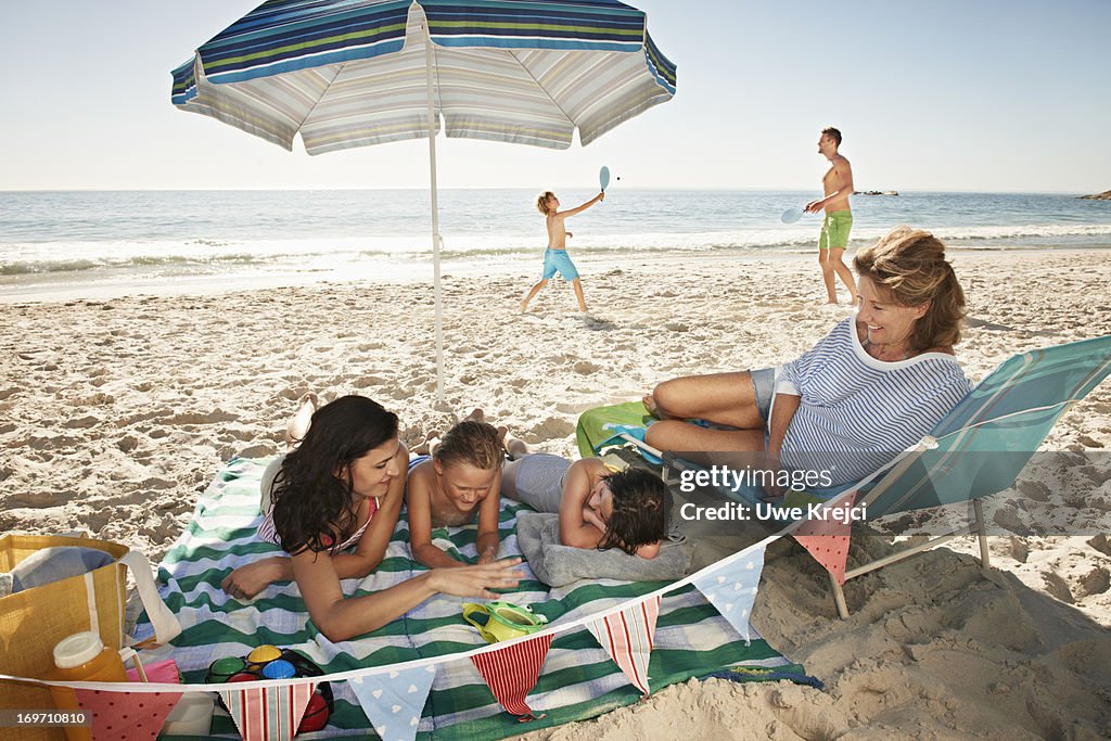 Happy family with grandmother on the beach
