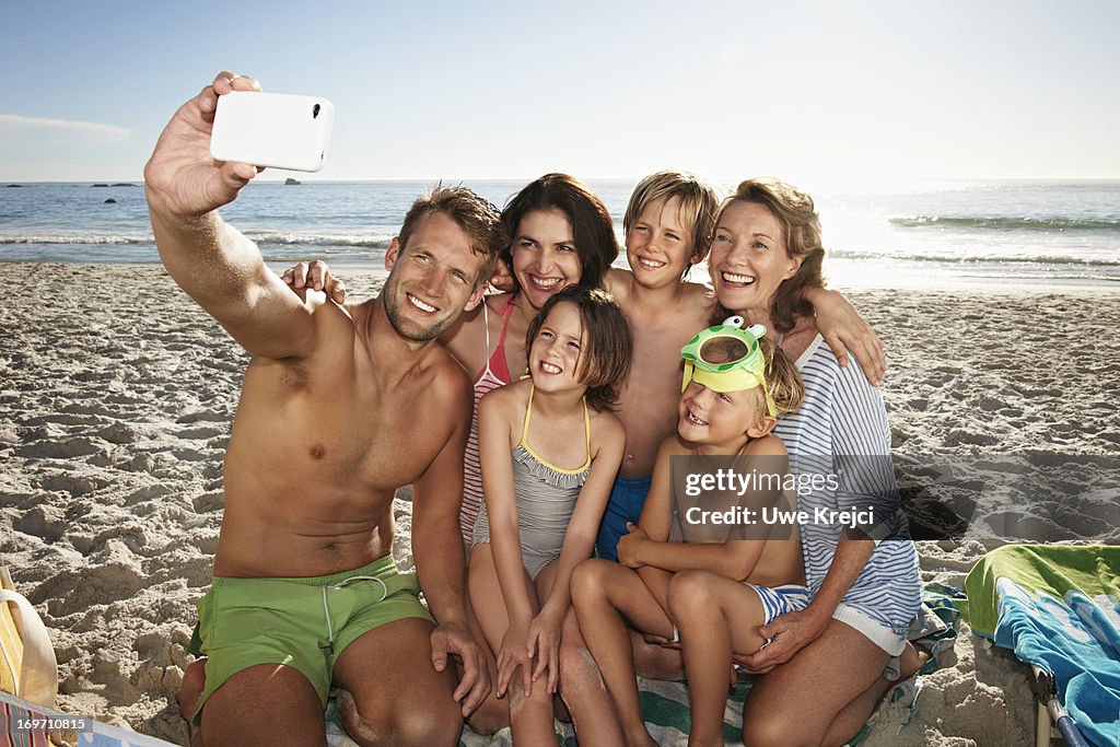 Family taking self portrait on beach