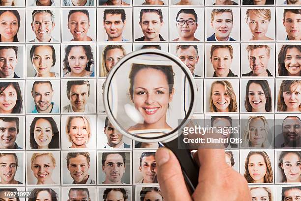magnifying glass on woman portrait amongst others - human face people grid stock pictures, royalty-free photos & images