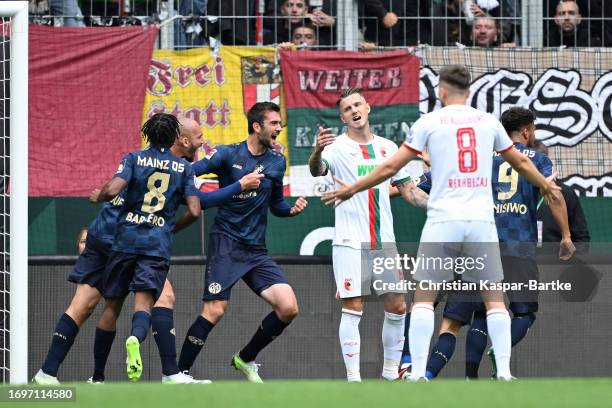 Stefan Bell of 1.FSV Mainz 05 celebrates with teammates after scoring the team's second goal that was later disallowed during the Bundesliga match...