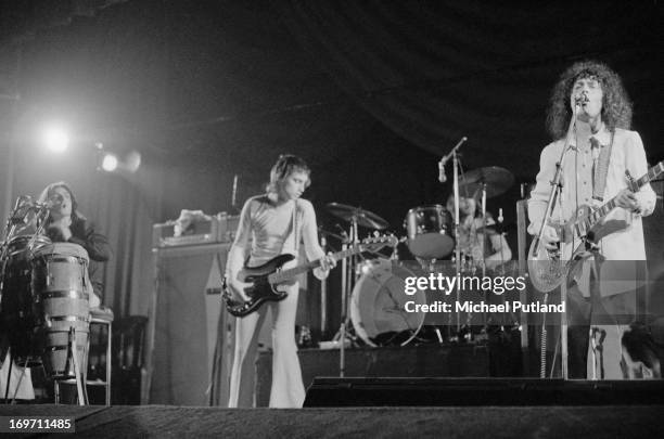 English glam rock group T-Rex performing at the Odeon, Birmingham, 9th June 1972. Left to right: Mickey Finn , Steve Currie , Bill Legend and Marc...