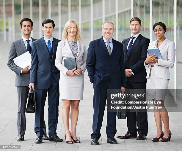 group of smiling business people outdoors - bussines group suit tie stock-fotos und bilder