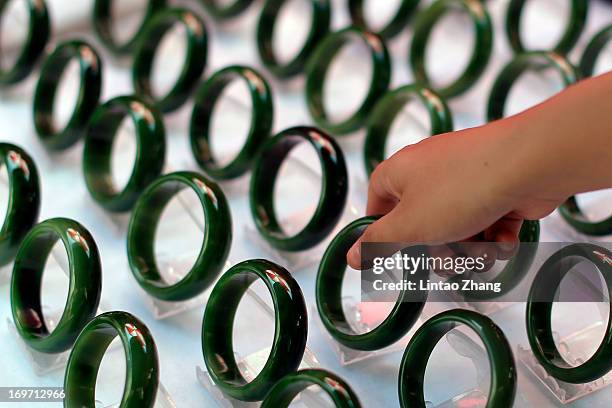 Customer selects jade bracelets at the Shifosi early market on May 27 in Shifosi town of Henan province, China. Zhenping is one of the 14 counties in...