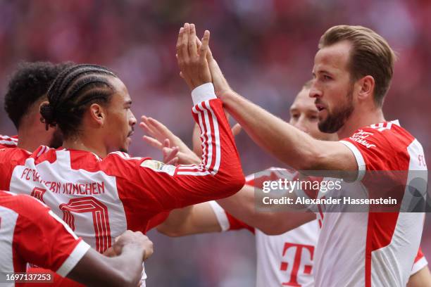 Leroy Sane of Bayern Munich celebrates with teammate Harry Kane after scoring the team's fourth goal during the Bundesliga match between FC Bayern...