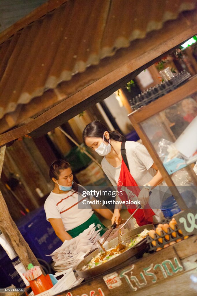 Two Thai Women Are Cooking Street Food In Chiang Khan High-Res Stock