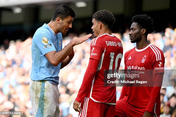 Morgan Gibbs-White of Nottingham Forest holds his neck after clashing with Rodri of Manchester City during the Premier League match between...