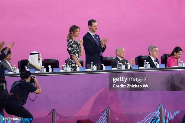 Syrian President Bashar al-Assad and his wife Asma attend the opening ceremony of the 19th Asian Games at Hangzhou Sports Park Stadium on September...