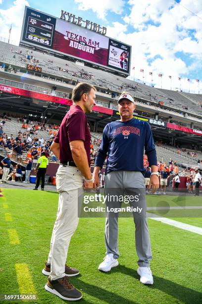 Head coach Hugh Freeze of the Auburn Tigers and Texas A&M Aggies athletic director Ross Mjork talk prior to the game at Kyle Field on September 23,...