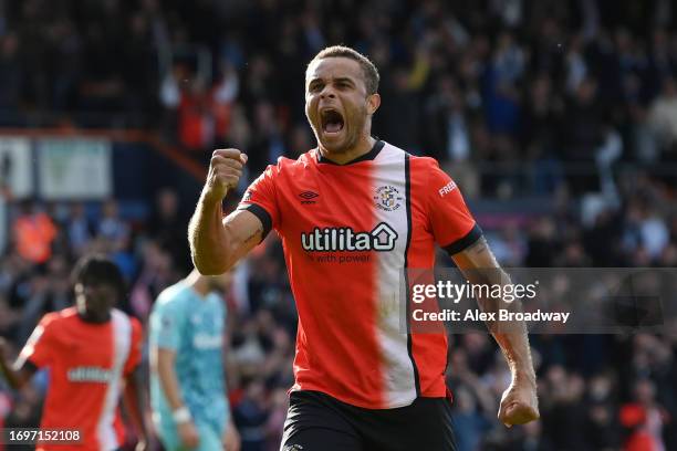 Carlton Morris of Luton Town celebrates after scoring their sides first goal from the penalty spot during the Premier League match between Luton Town...