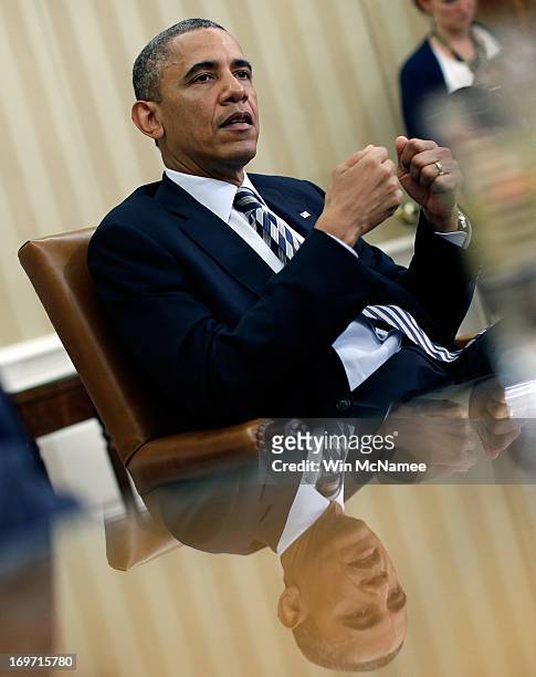 President Barack Obama speaks during a meeting with NATO Secretary General Anders Fogh Rasmussen in the Oval Office of the White House May 31, 2013...