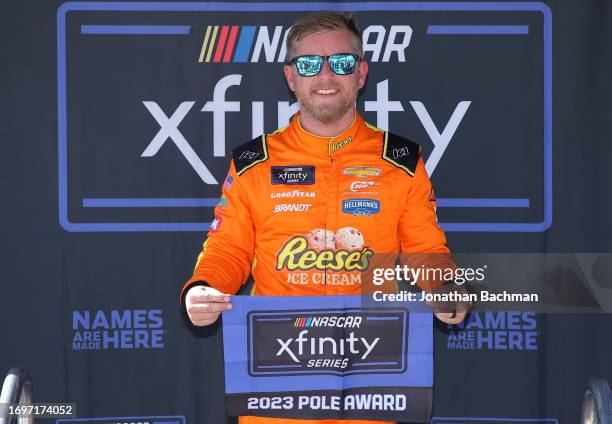 Justin Allgaier, driver of the Reese's Ice Cream/Sam's Club Chevrolet, poses for photos after winning the pole award during qualifying for the NASCAR...