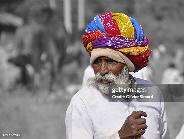 This is a photo taken of a shepherd during the sale of Pushkar Camel Fair. He had just arrived with his herd and seeking a place to settle. Held each...